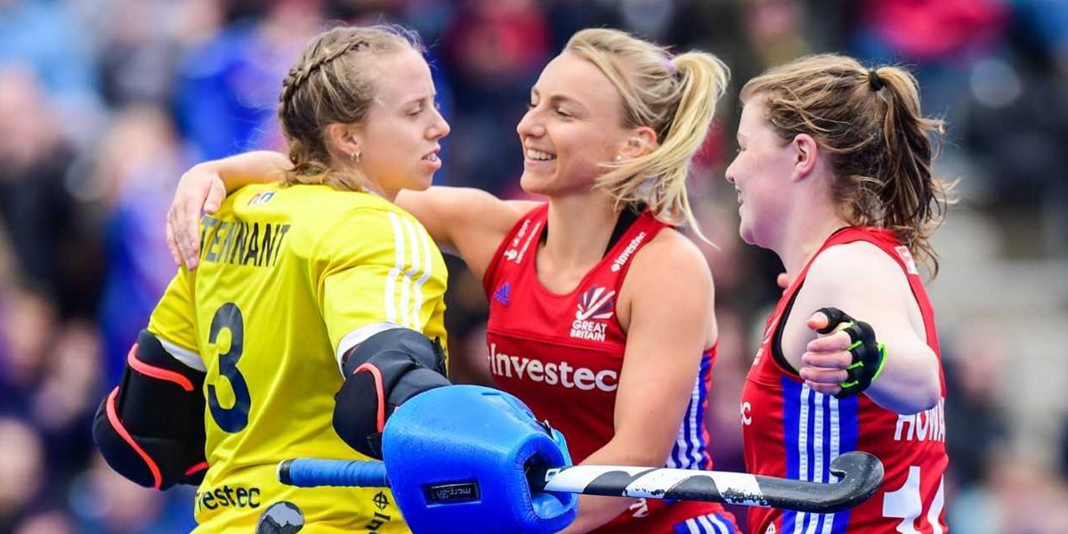 Amy Tennat hugs team mates Hannah martin and tess howard