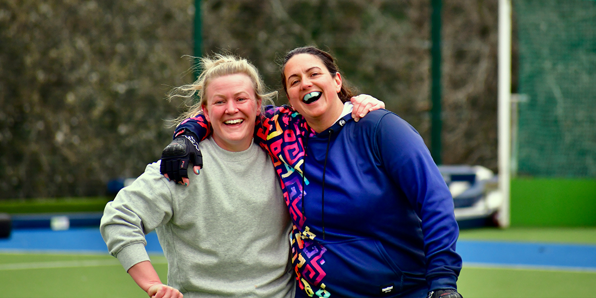 female players hugging and smiling