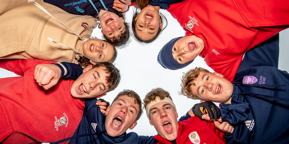 Young players looking down and smiling to camera 